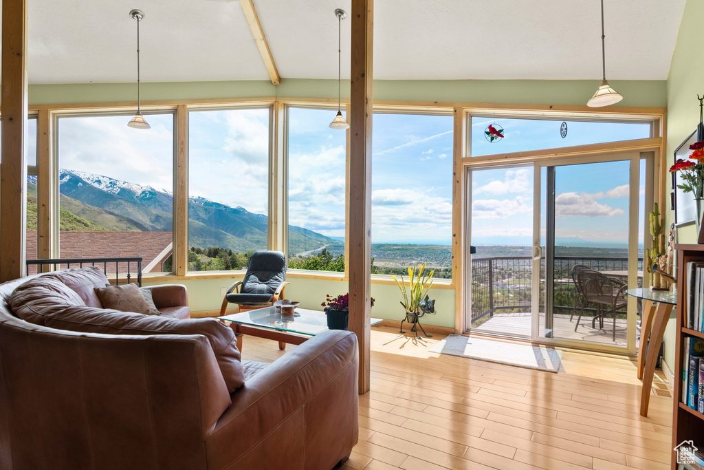 Sunroom / solarium with wood finished floors and a mountain view