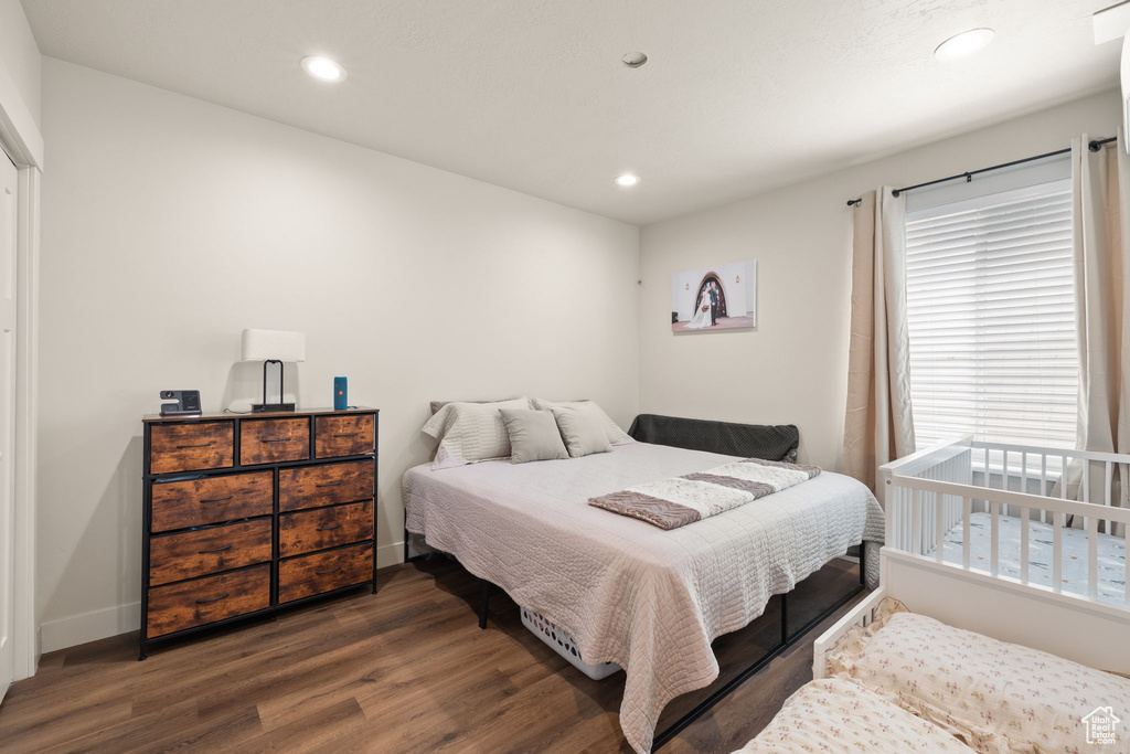 Bedroom featuring recessed lighting, dark wood-style flooring, and baseboards