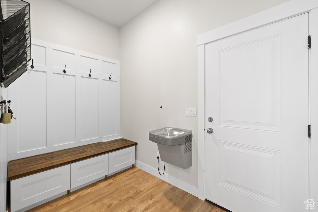 Mudroom with baseboards and light wood-type flooring