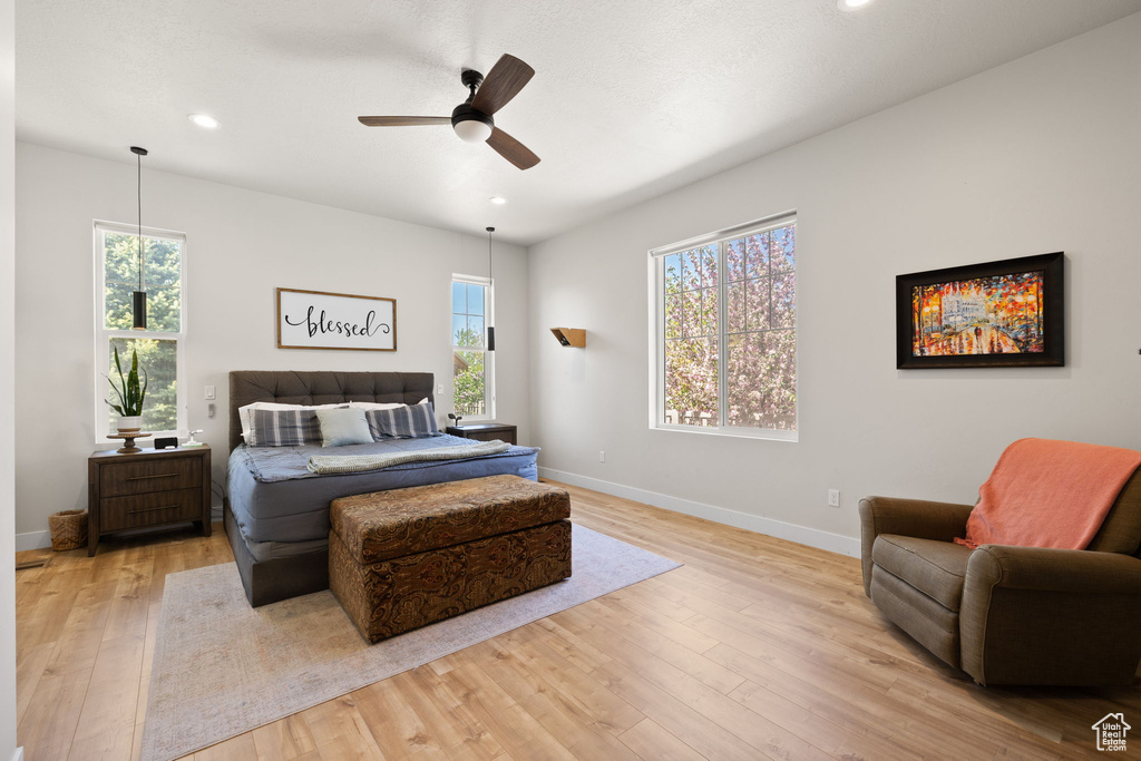 Bedroom with light wood-style floors, baseboards, ceiling fan, and recessed lighting