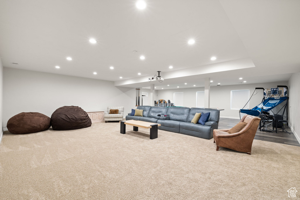 Carpeted living area with recessed lighting