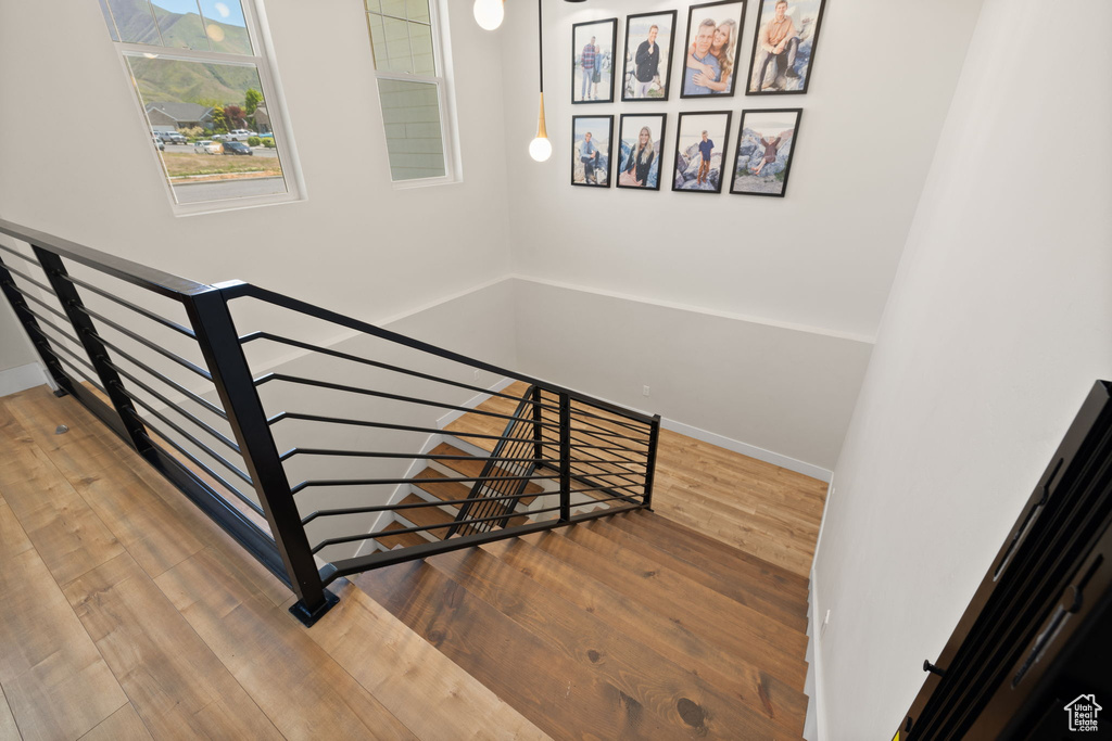 Stairway with wood-type flooring and baseboards