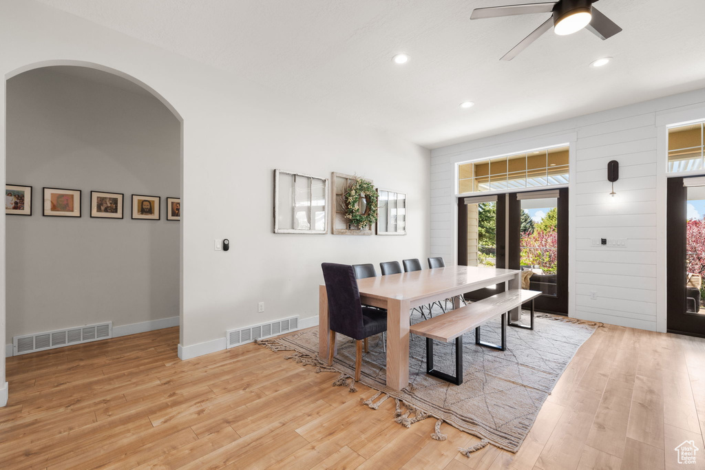 Dining space with arched walkways, visible vents, and recessed lighting