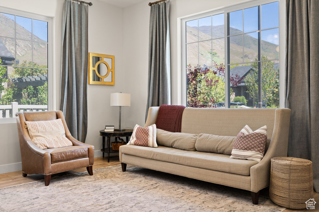 Living area with baseboards and wood finished floors