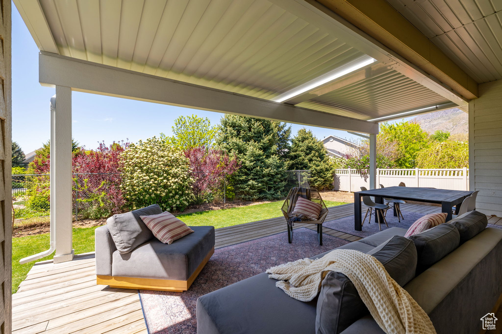 View of patio / terrace with outdoor dining area, a fenced backyard, a wooden deck, and an outdoor hangout area
