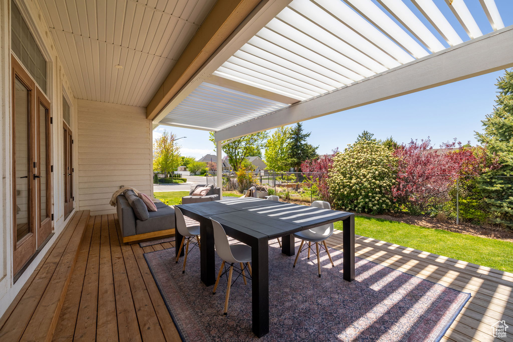 Wooden deck featuring fence, a patio, and outdoor dining area