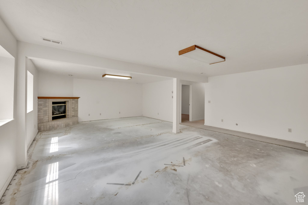 Unfurnished living room with a brick fireplace