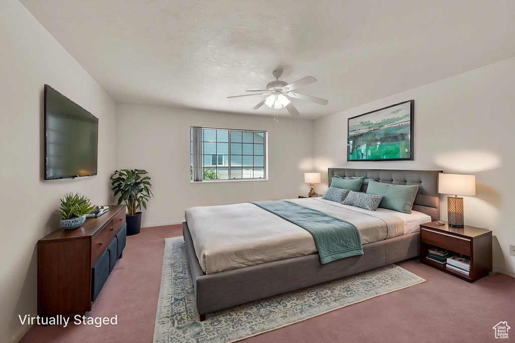 Bedroom featuring carpet floors, baseboards, and a ceiling fan