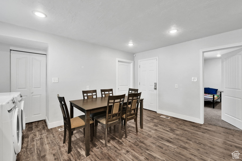 Dining room featuring washing machine and dryer, dark wood-style flooring, recessed lighting, and baseboards