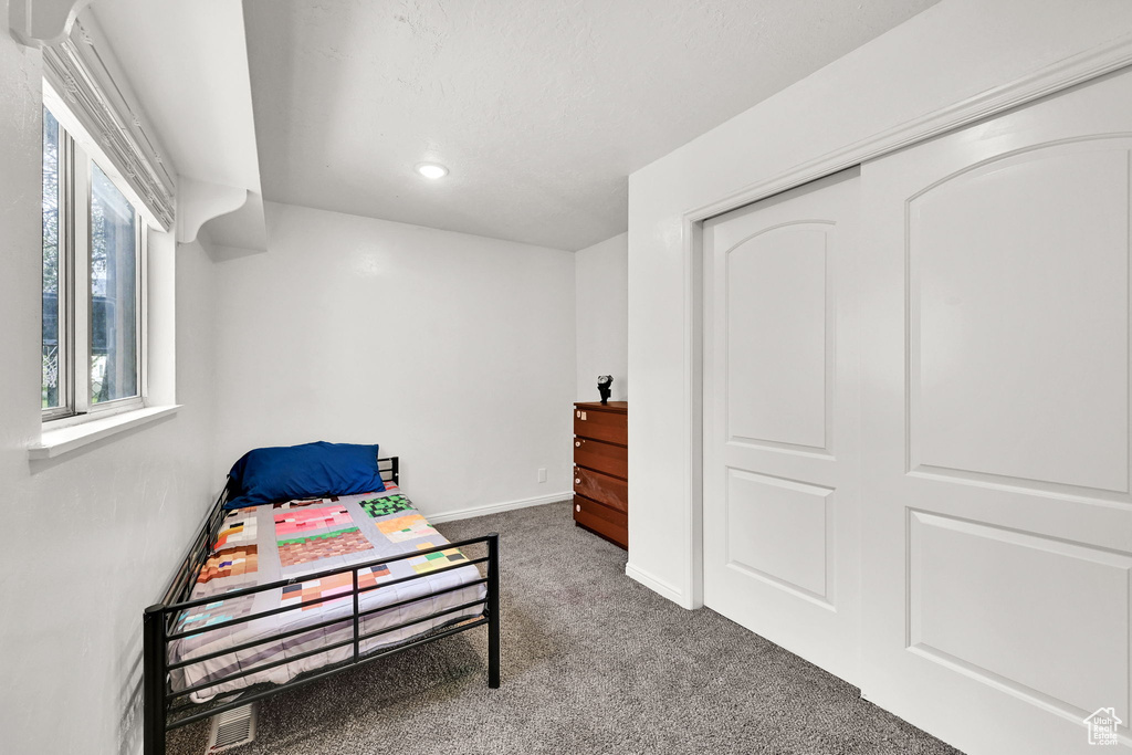 Carpeted bedroom with recessed lighting and baseboards