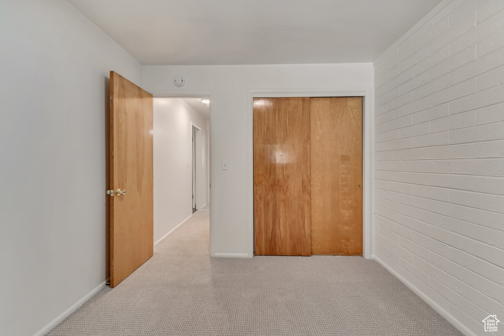 Unfurnished bedroom with carpet and a closet