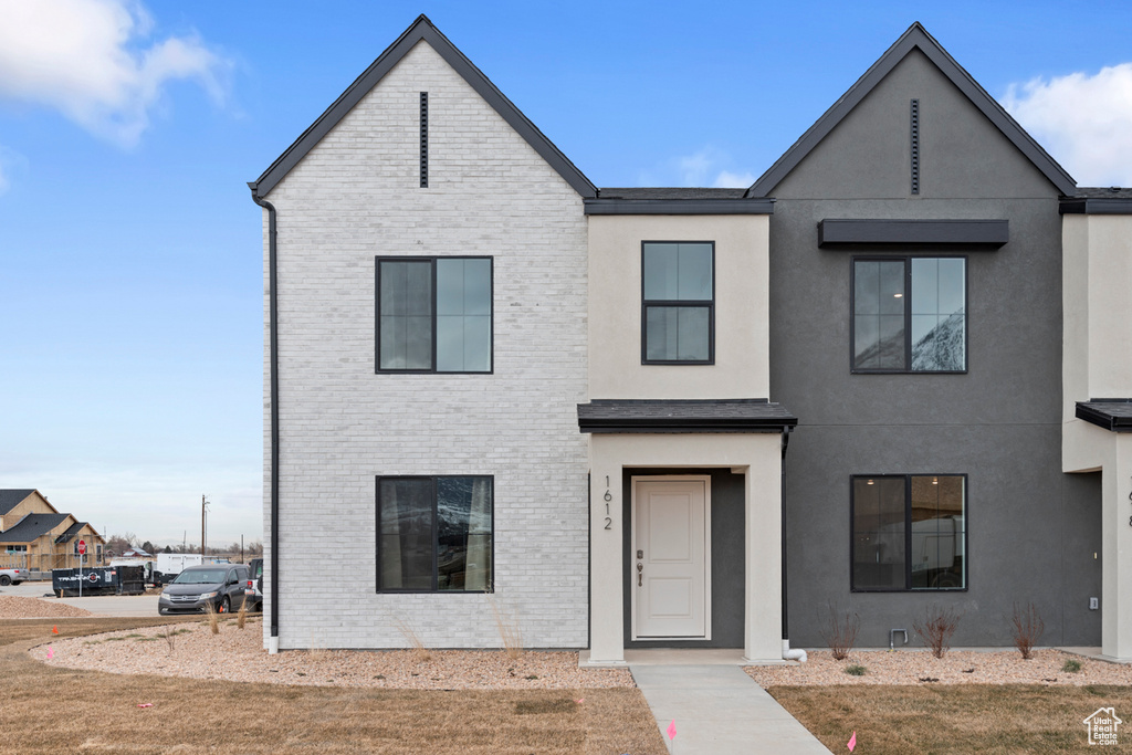 View of front of property with brick siding and stucco siding