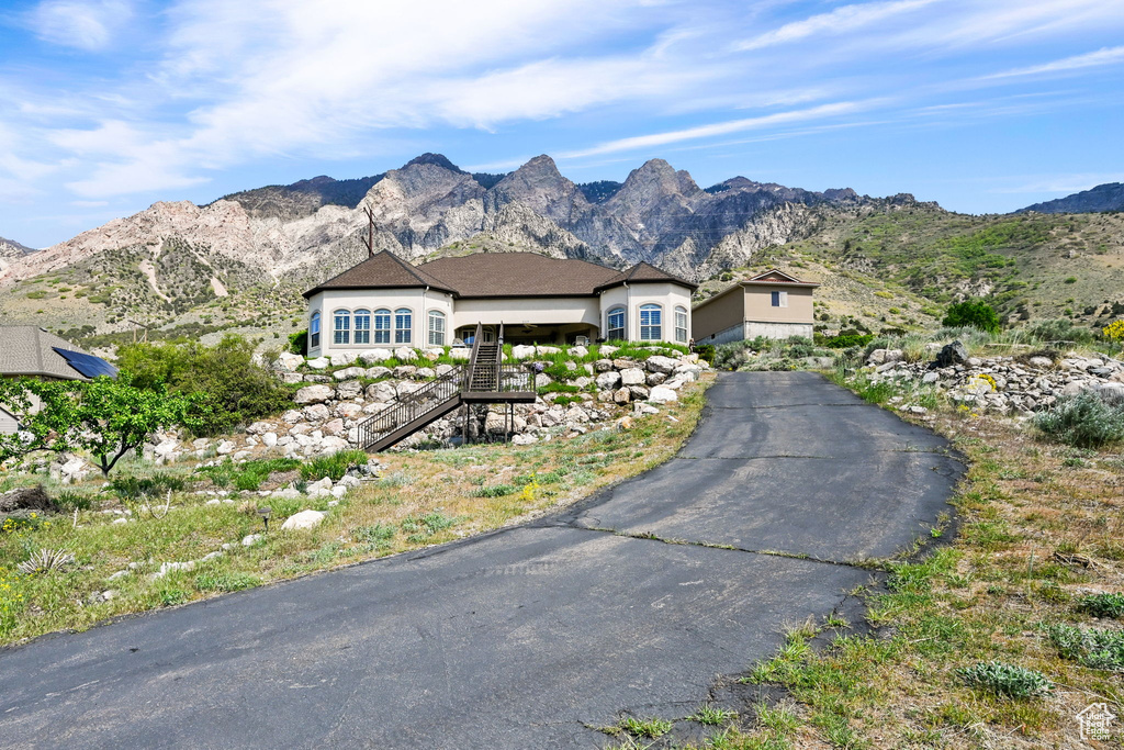 Single story home with stairway and a mountain view