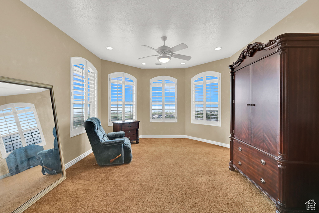 Sitting room featuring ceiling fan, light carpet, baseboards, and recessed lighting