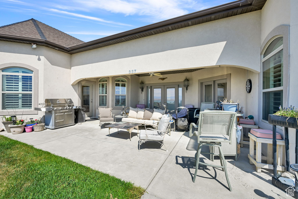 View of patio / terrace featuring ceiling fan, an outdoor hangout area, french doors, and a grill