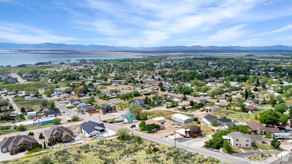 Drone / aerial view featuring a water and mountain view and a residential view