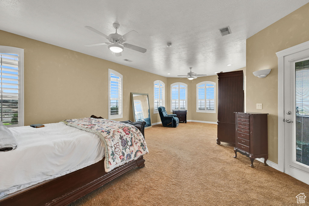 Bedroom featuring light colored carpet, baseboards, and visible vents