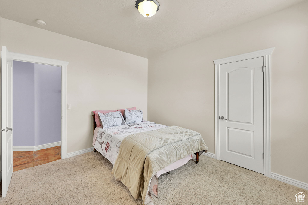 Bedroom featuring carpet floors and baseboards