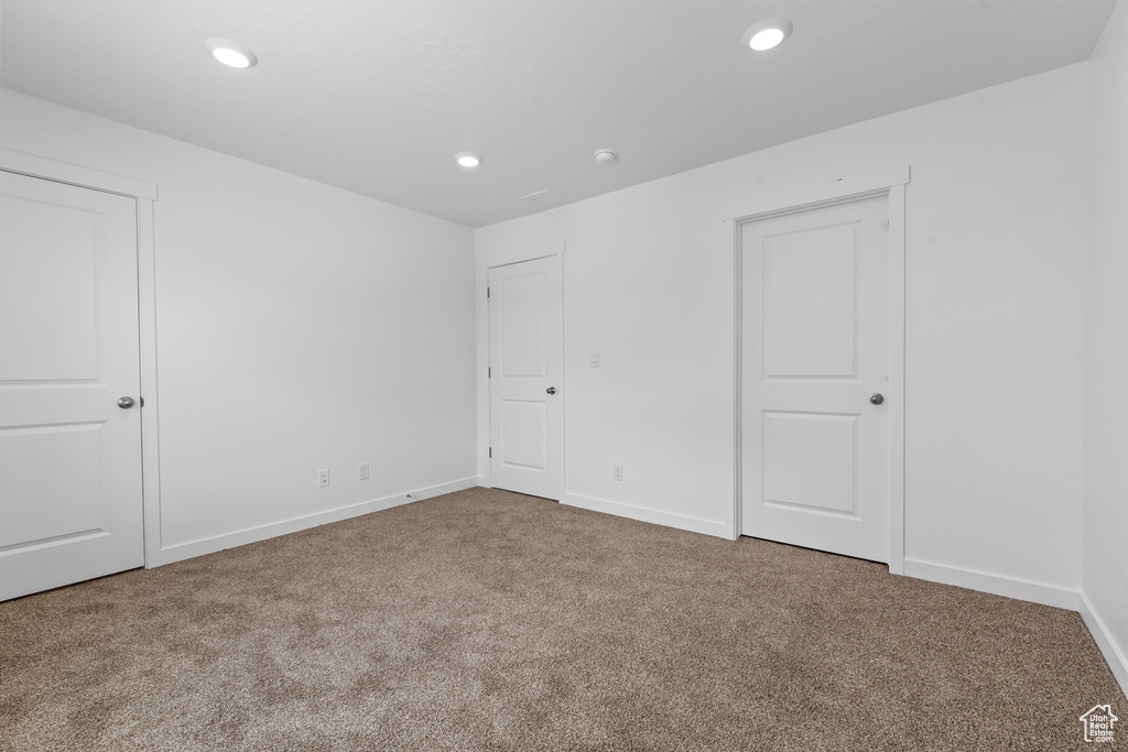 Unfurnished bedroom with carpet flooring, baseboards, and recessed lighting