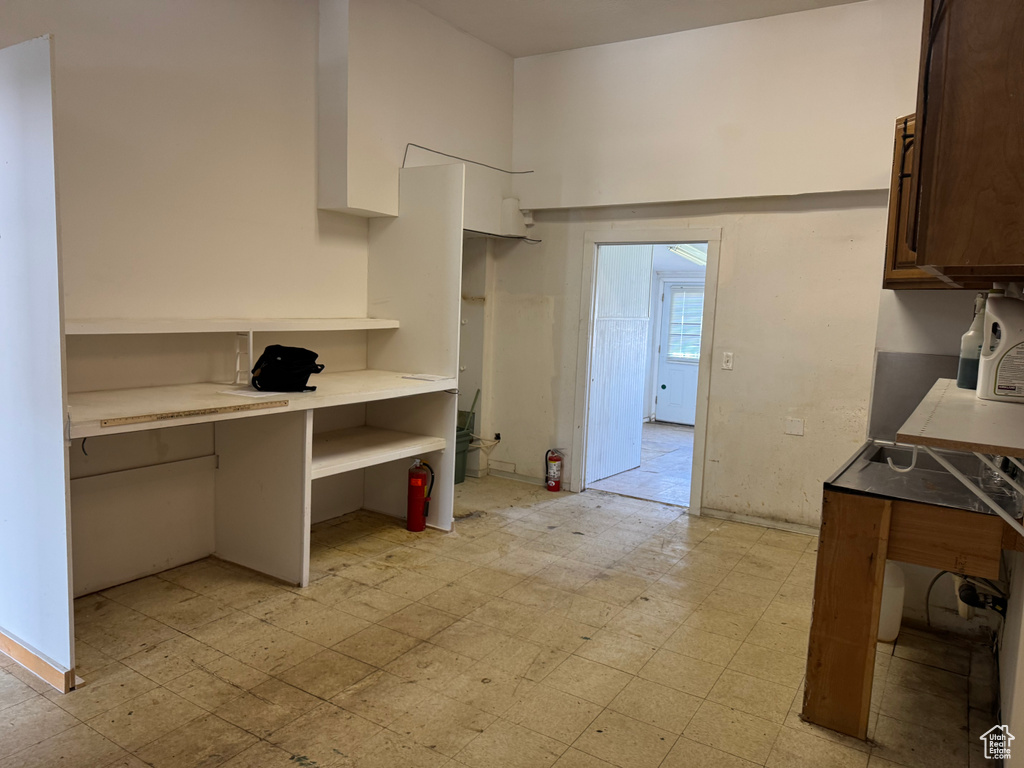 Kitchen with light floors, light countertops, and white cabinets