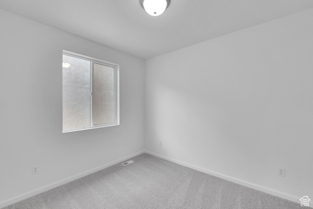 Unfurnished room with baseboards and carpet flooring