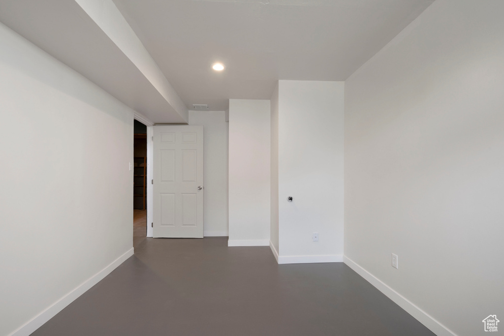 Spare room with concrete floors, baseboards, and recessed lighting
