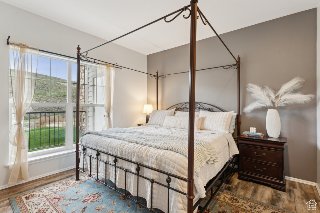 Bedroom featuring baseboards and wood finished floors