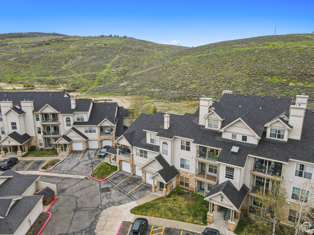 Birds eye view of property with a mountain view and a residential view