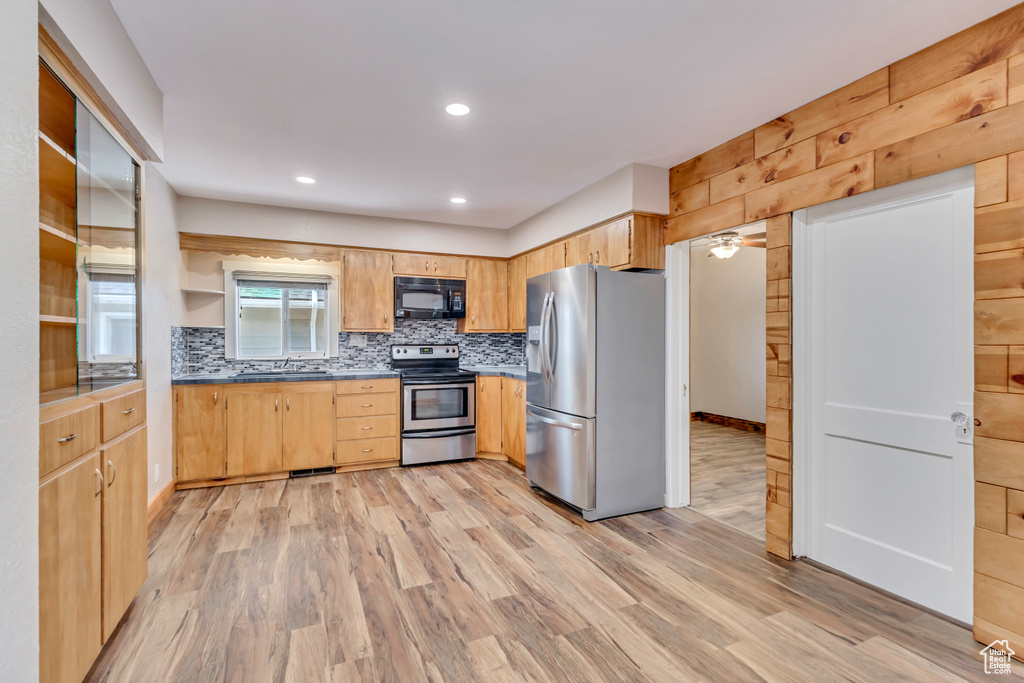 Kitchen featuring appliances with stainless steel finishes, a sink, light wood-style floors, light brown cabinets, and recessed lighting