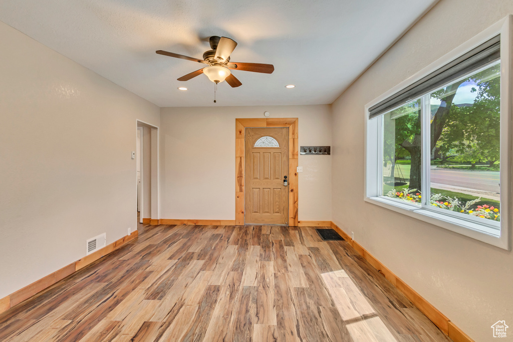 Foyer with light wood-style flooring, baseboards, a ceiling fan, and recessed lighting
