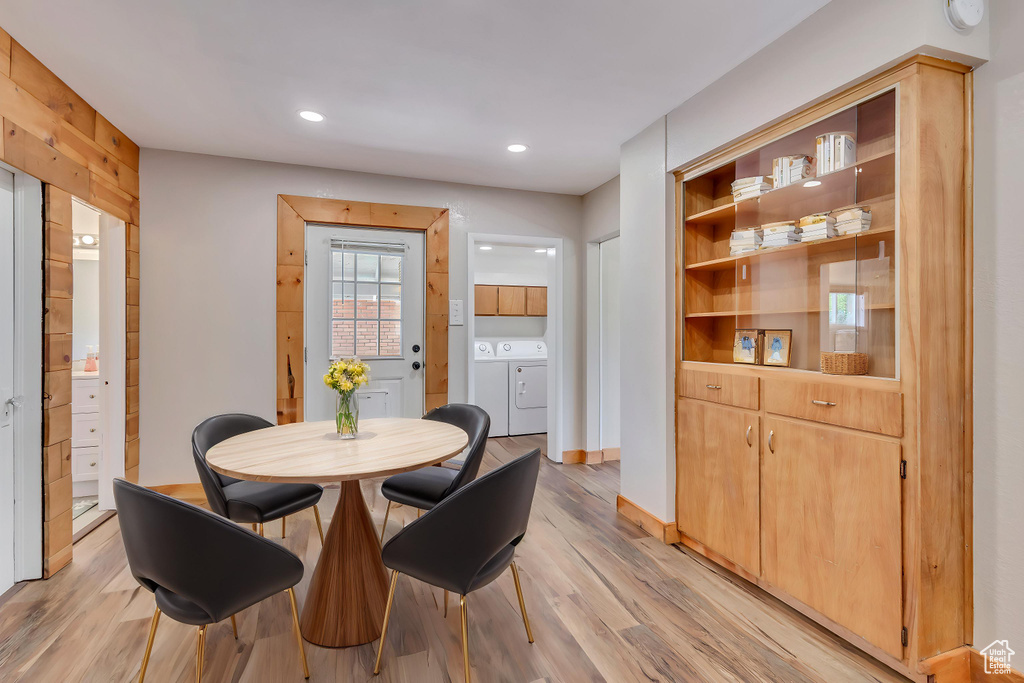 Dining room with light wood-type flooring, washer and clothes dryer, and recessed lighting