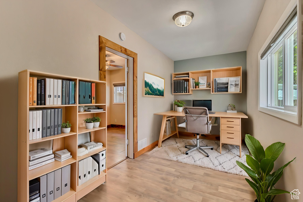 Office with wood finished floors and baseboards