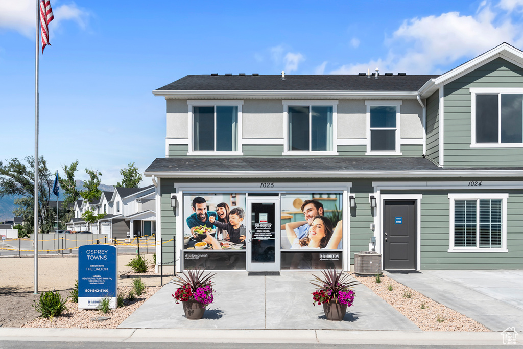 View of front of home with cooling unit