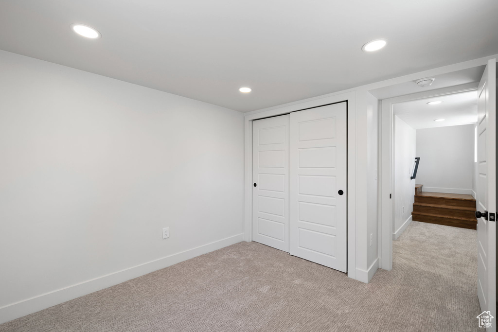 Unfurnished bedroom with carpet floors, recessed lighting, baseboards, and a closet
