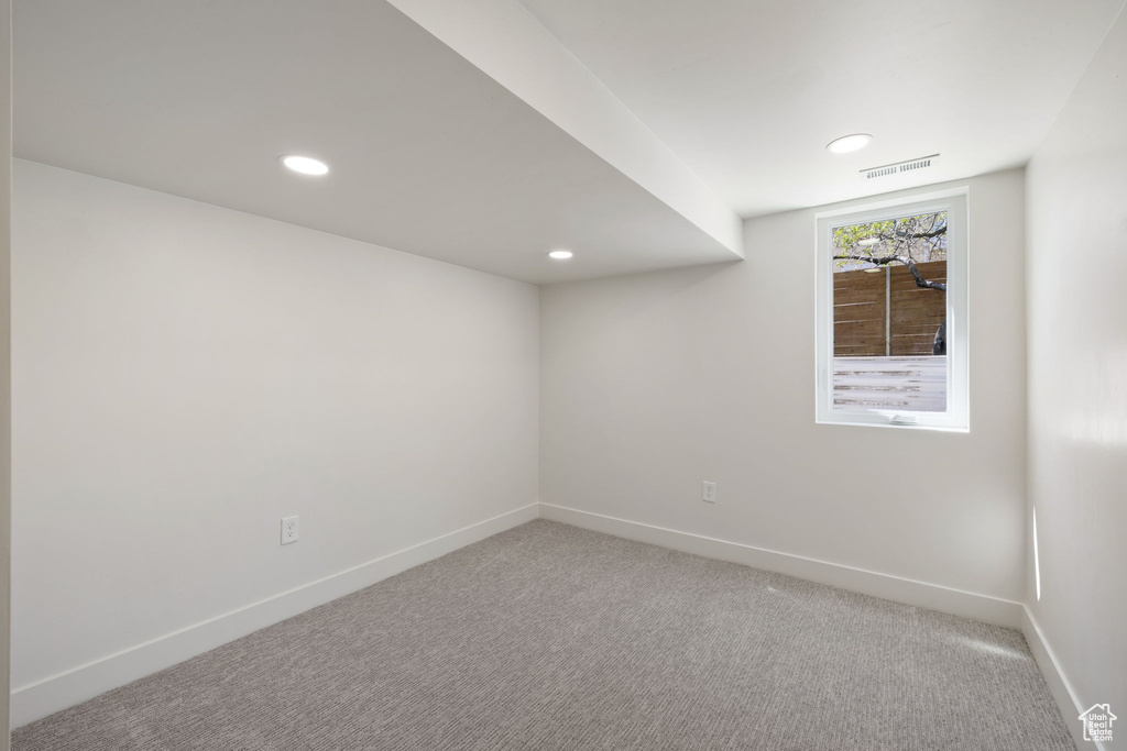 Empty room with carpet floors, recessed lighting, and baseboards