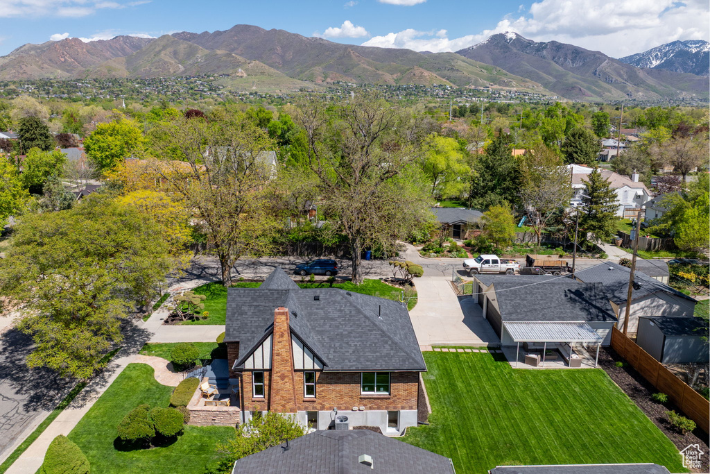 Aerial view of property and surrounding area with a mountain backdrop