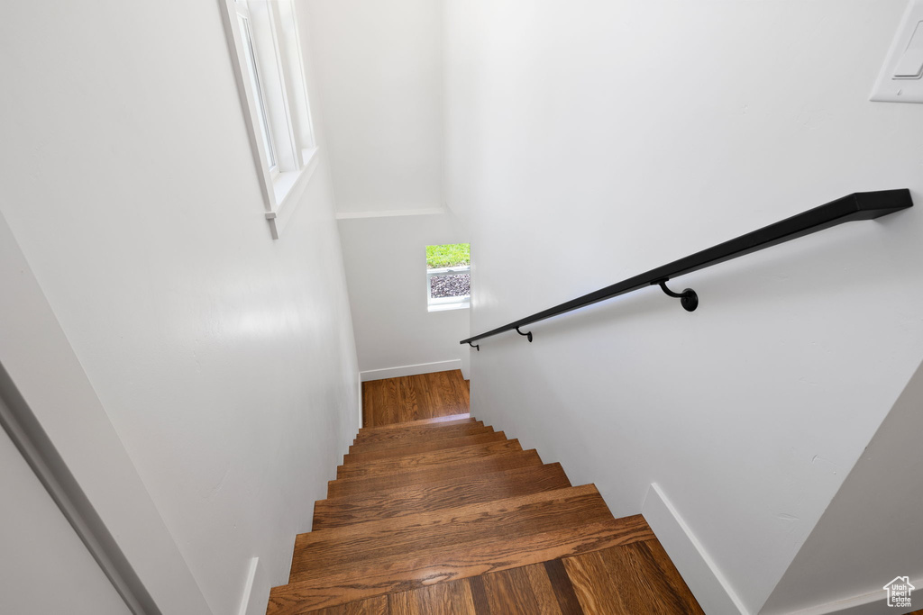 Stairway featuring wood finished floors and baseboards