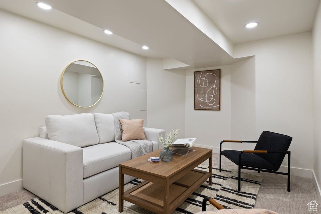 Living room with baseboards, recessed lighting, and light colored carpet