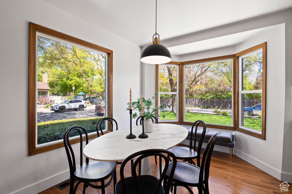 Dining area with baseboards and wood finished floors