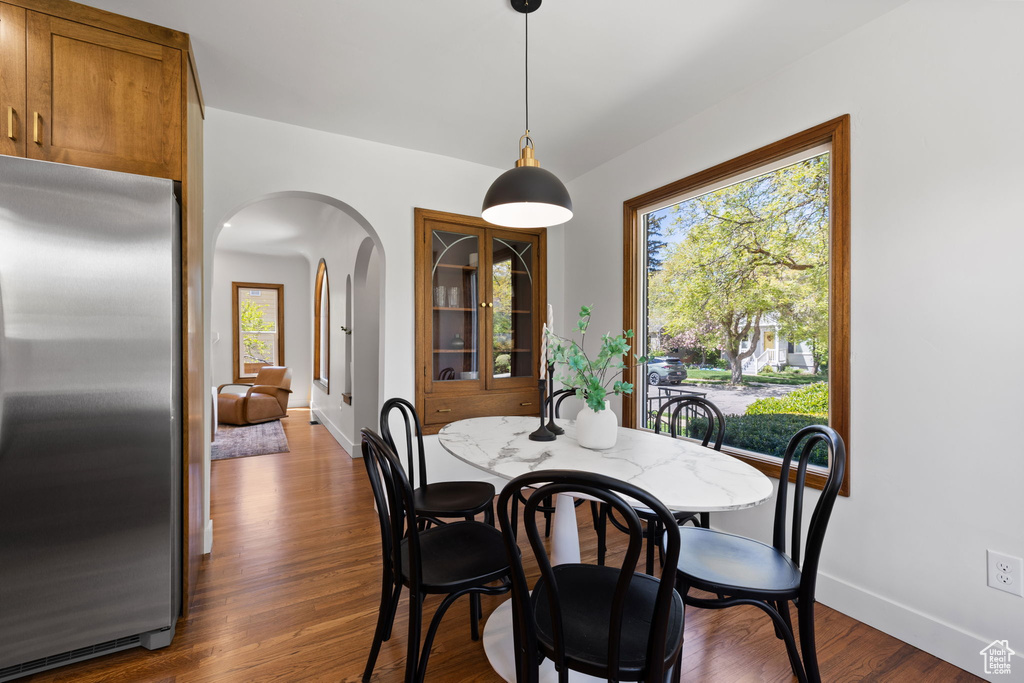 Dining space featuring arched walkways, plenty of natural light, and baseboards