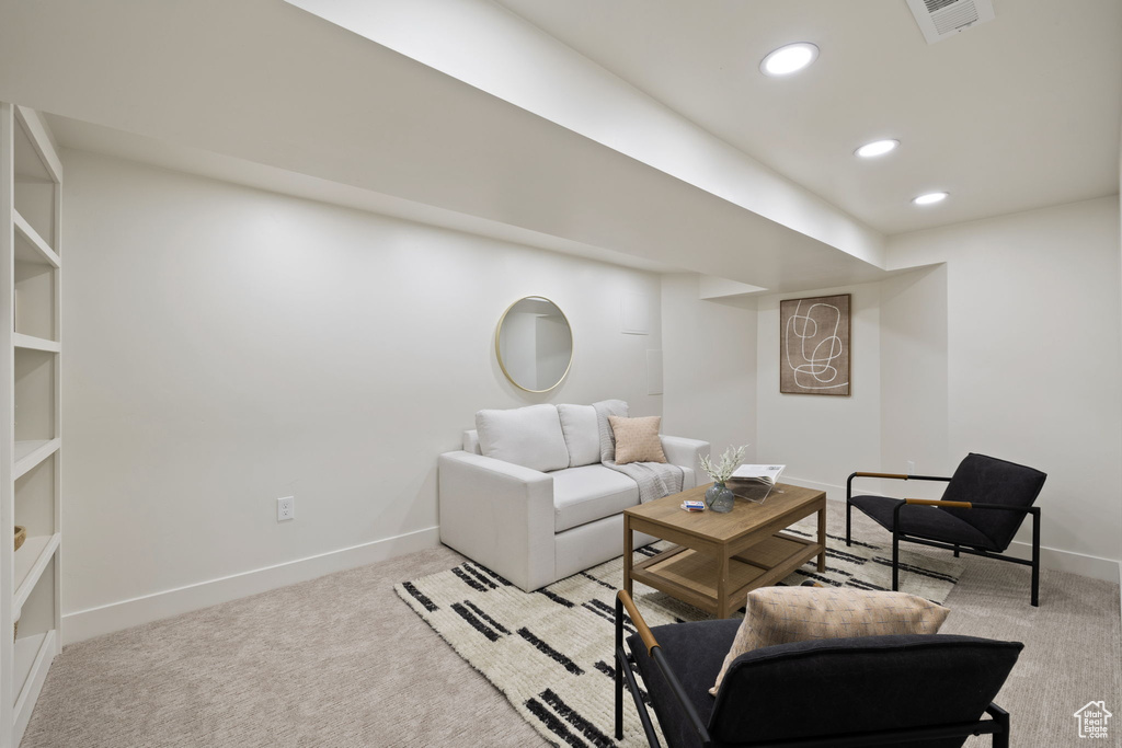 Living room featuring light colored carpet, baseboards, and recessed lighting