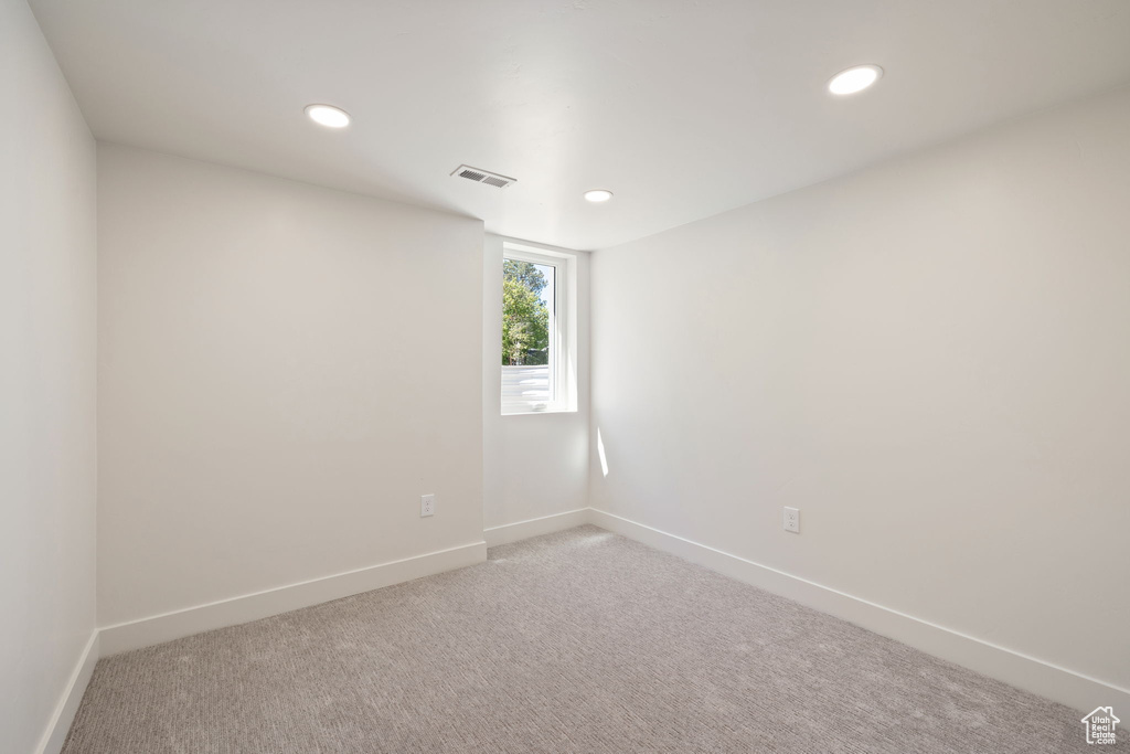 Empty room featuring baseboards, recessed lighting, and carpet flooring