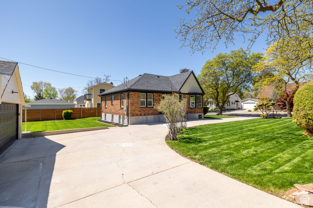 View of side of property with brick siding and roof with shingles