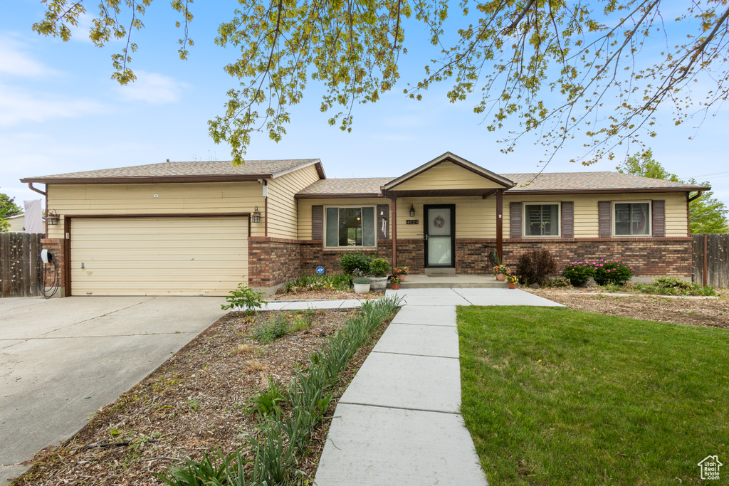 Ranch-style house with brick siding, a garage, and driveway
