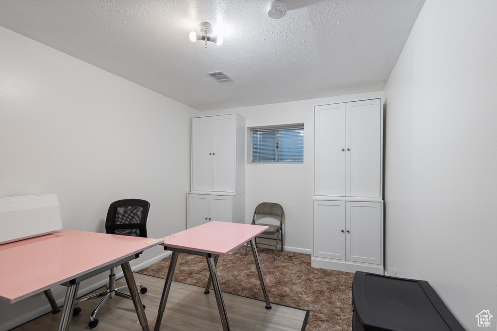Office area featuring a textured ceiling and baseboards