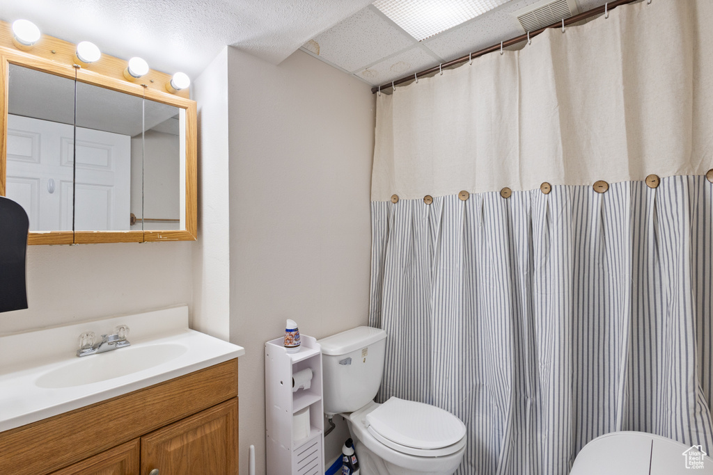 Full bathroom featuring toilet and vanity