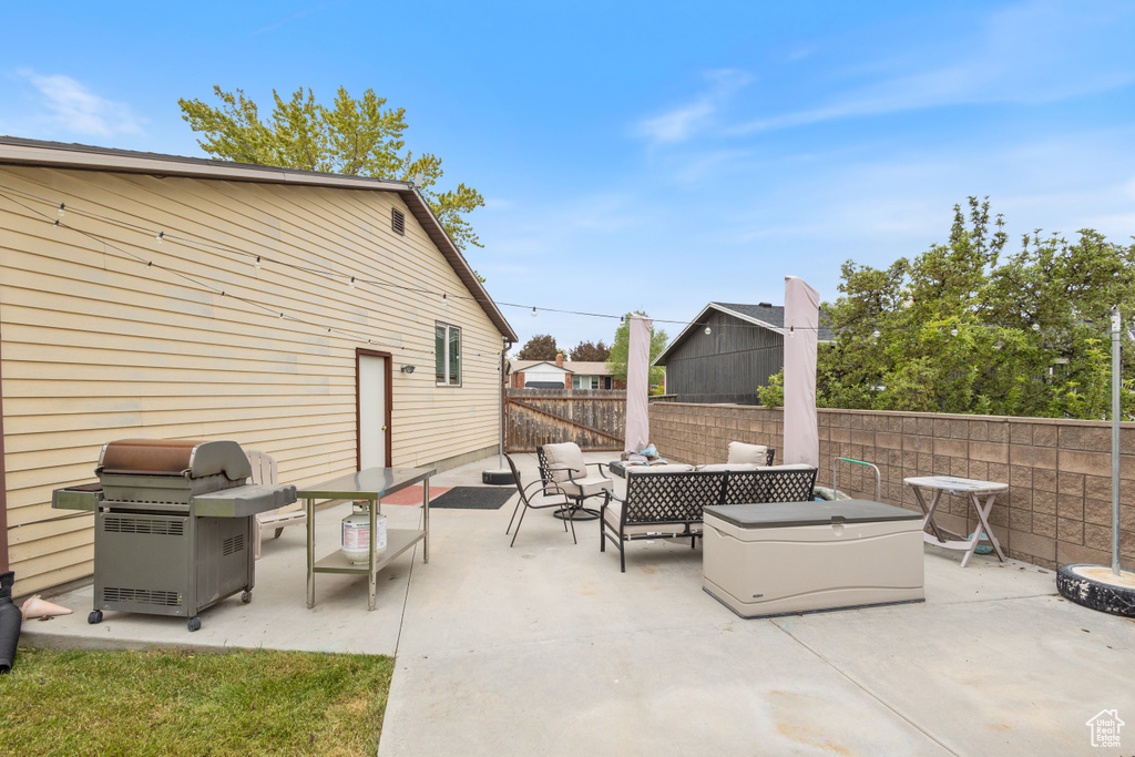 View of patio / terrace with a grill, an outdoor hangout area, and a fenced backyard