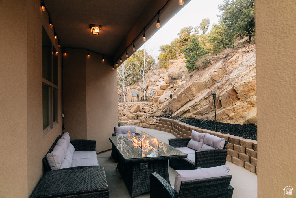 View of patio with an outdoor living space with a fire pit