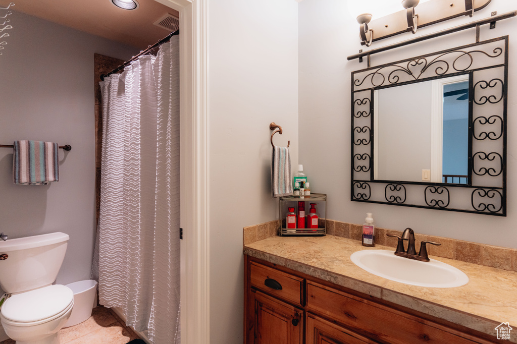 Full bath featuring toilet and vanity