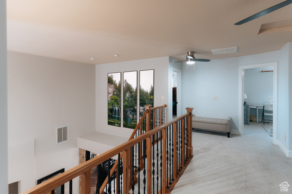 Hall featuring an upstairs landing, carpet, and baseboards